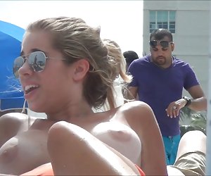 Topless beach girl with massive tits