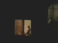 Horny couple caught playing at open window