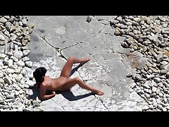 Slim tanned girl lying, legs spread got slippers on pussy